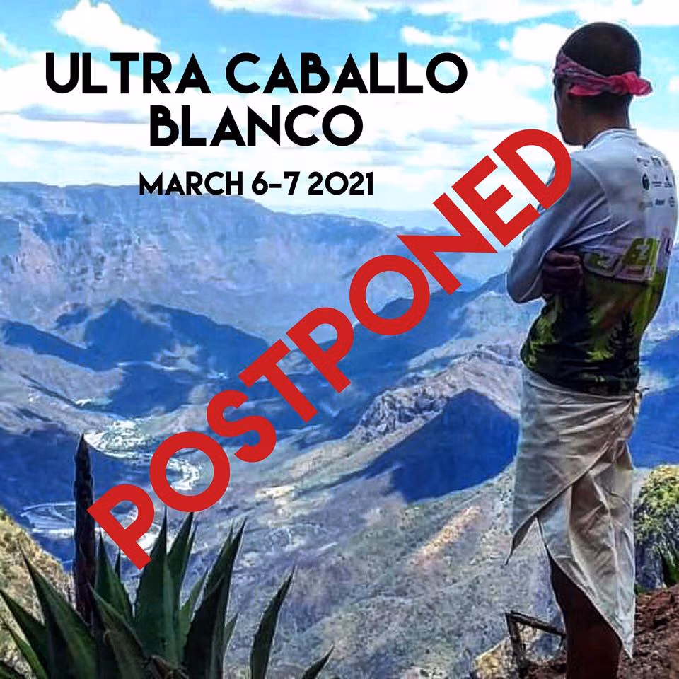 Person standing on a mountain overlooking a scenic valley with the text "Ultra Caballo Blanco March 6-7 2021" and a red "POSTPONED" stamp across the image.