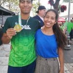 Juan Felipe Arellanes Ruíz (left) and Areli Arellanes Ruiz (right) smiling and posing together after a marathon event, with Juan holding a medal.