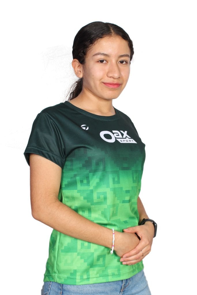 Mane Peña in a green Oax Sport shirt, smiling and posing with hands together.