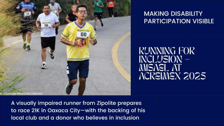 Visually impaired runner Misael Pérez Robles wearing a yellow Jule Perro jersey during a road race, surrounded by other runners on a curved street in Oaxaca.