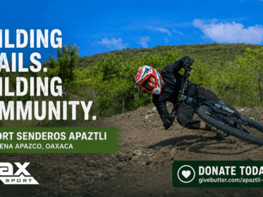 Mountain biker riding a hand-built dirt trail at Senderos Apaztli in Magdalena Apazco, Oaxaca, with Oax Sport branding and a donation callout.