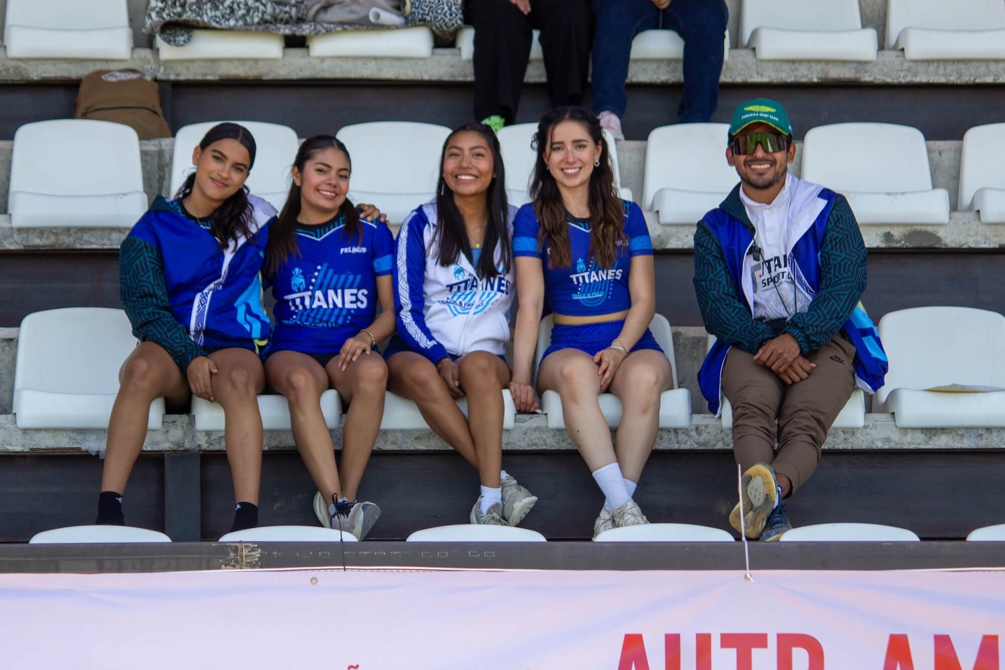 Titanes athletes and team members sit together in the stands at Parque Primavera during the Festival Atlético Autotransportes Avendaño Morales 2026.