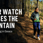 Runner on a pine forest trail in Oaxaca with text reading “Your Watch Misses the Mountain” and Oax Sport logo.