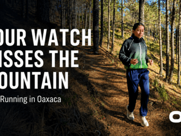 Runner on a pine forest trail in Oaxaca with text reading “Your Watch Misses the Mountain” and Oax Sport logo.