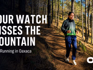 Runner on a pine forest trail in Oaxaca with text reading “Your Watch Misses the Mountain” and Oax Sport logo.