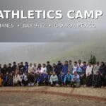 Group of athletes and coaches from the 2026 Oax Sport–Titanes Athletics Camp posing outdoors in Ixtepeji, Oaxaca, with misty mountains behind them. Text reads “2026 Athletics Camp” and “Oax Sport + Titanes • July 9–12 • Oaxaca, Mexico.”