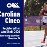 Carolina Cinco running in race bib 155, alongside Oax Sport branding and the headline “Registered for Abu Dhabi 2026.”