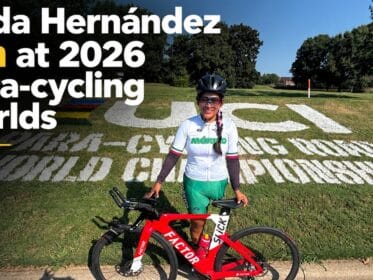Gilda Hernández stands beside her red racing bicycle at the 2026 UCI Para-cycling Road World Championships in Huntsville, with text announcing her 5th-place finish.